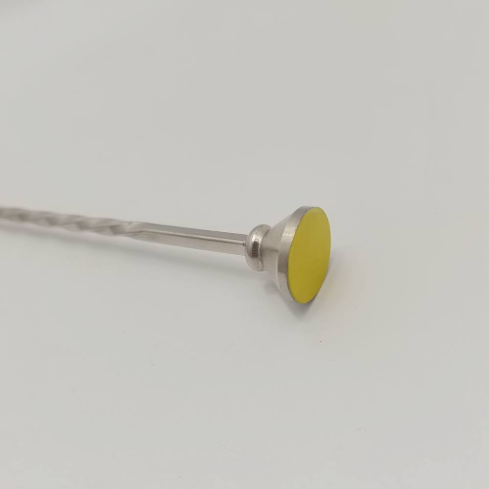 LARBO silver bar spoon with yellow disc topper close-up showing twisted handle detail